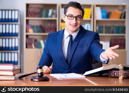 Handsome judge with gavel sitting in courtroom