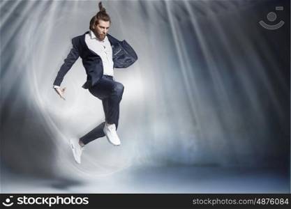 Handsome jumping businessman wearing stylish stuff