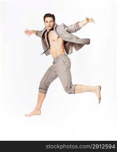 Handsome jumping guy on suit isolated on a white background