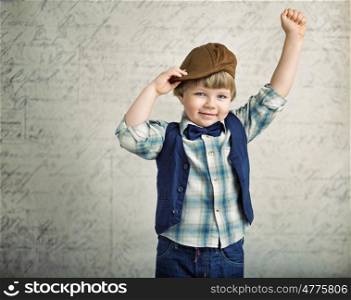 Handsome little boy with a wining gesture