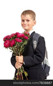 Handsome little schoolboy is holding flowers isolated on white background. Back to school