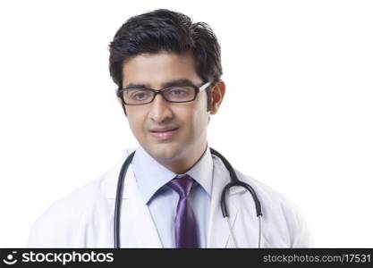 Handsome male doctor smiling over white background