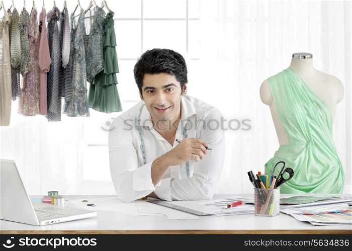 Handsome male fashion designer smiling in studio