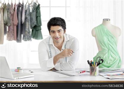 Handsome male fashion designer smiling in studio