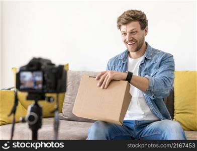handsome male recoding unboxing video home