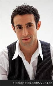 Handsome male wearing a white shirt and black pinstripe vest, isolated