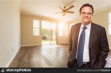 Handsome Male Wearing Suit and Tie In Empty Room of House.