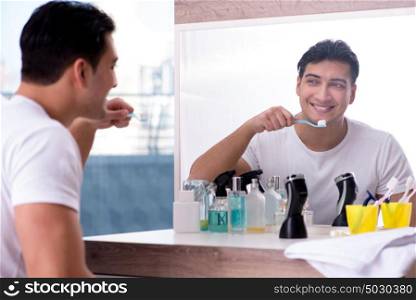 Handsome man brushing teeth in the morning