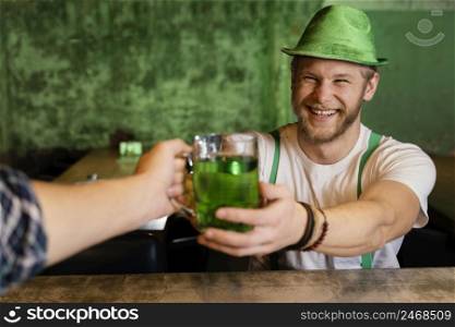 handsome man celebrating st patrick s day bar with drinks