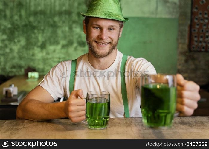 handsome man celebrating st patrick s day with drinks bar