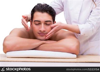 Handsome man during spa massaging session