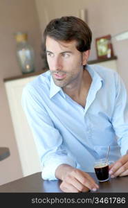 Handsome man having coffee at home