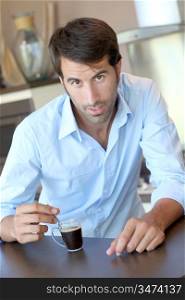 Handsome man having coffee at home