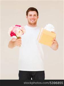 handsome man holding bouquet of flowers and gift box