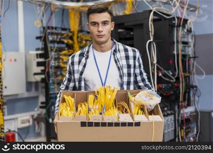 handsome man holding box with different optical fiber