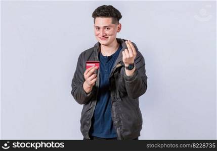 Handsome man holding credit card, A guy holding credit card smiling, electronic payment concept