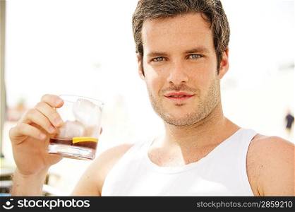 Handsome man holding glass