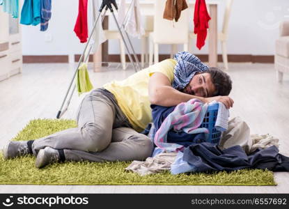 Handsome man husband doing laundering at home