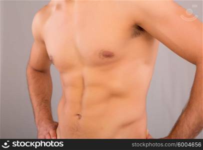 Handsome man in a great shape, isolated over a copy space background