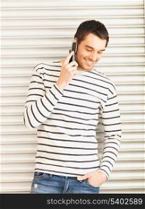 handsome man in casual clothes talking on the phone