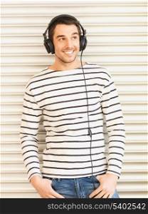 handsome man in casual clothes with headphones