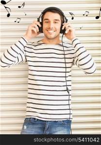 handsome man in casual clothes with headphones