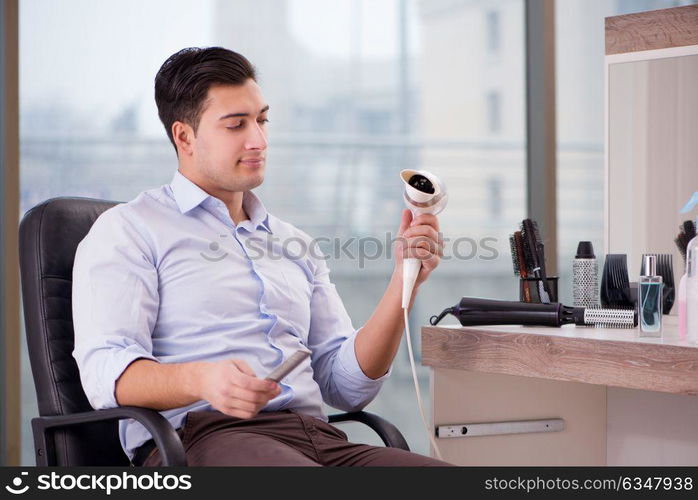 Handsome man in hair salon doing haircut