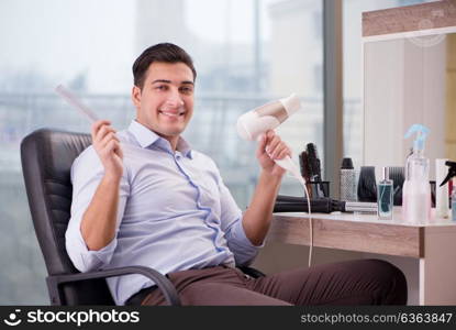 Handsome man in hair salon doing haircut