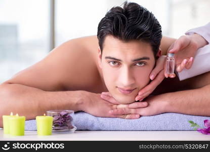 Handsome man in spa massage concept