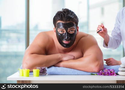 Handsome man in spa massage concept