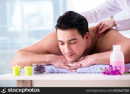 Handsome man in spa massage concept