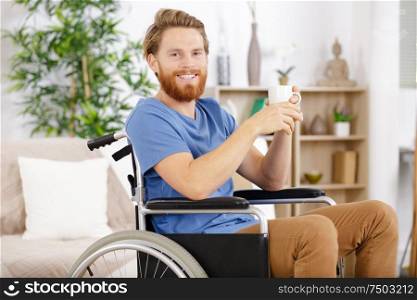 handsome man in wheelchair having a break