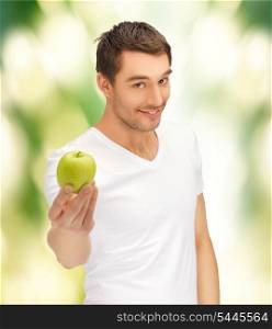 handsome man in white shirt with green apple