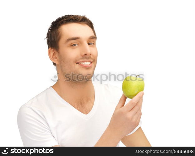 handsome man in white shirt with green apple