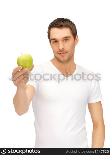 handsome man in white shirt with green apple