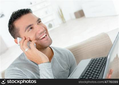 handsome man is talking on the mobile phone and smiling