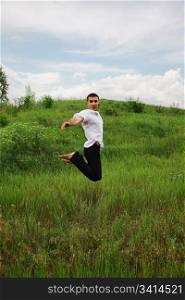 handsome man jumps on the nature. outdoor shot