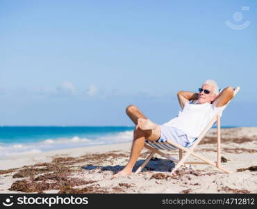 Handsome man on the beach . Relaxing at sea