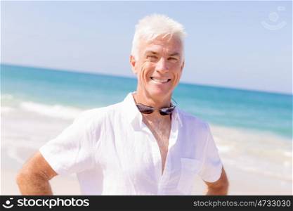 Handsome man on the beach . Relaxing at sea