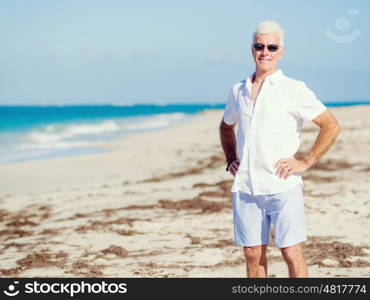 Handsome man on the beach . Relaxing at sea