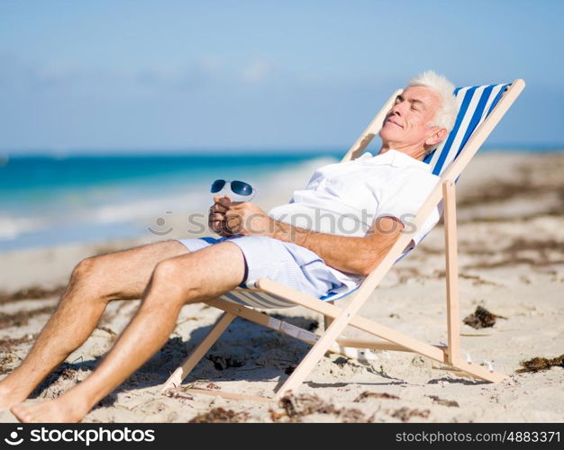 Handsome man on the beach . Relaxing at sea