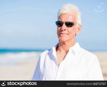 Handsome man on the beach . Relaxing at sea