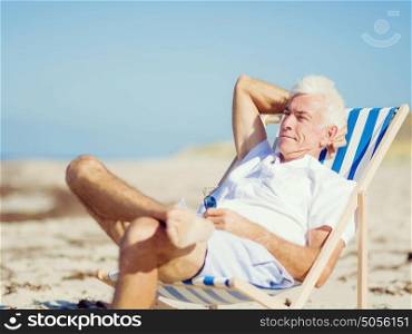 Handsome man on the beach . Relaxing at sea