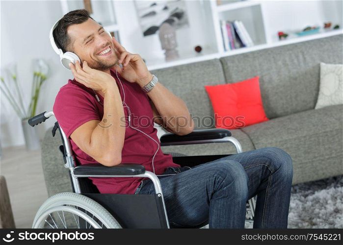 handsome man on wheelchair enjoying music