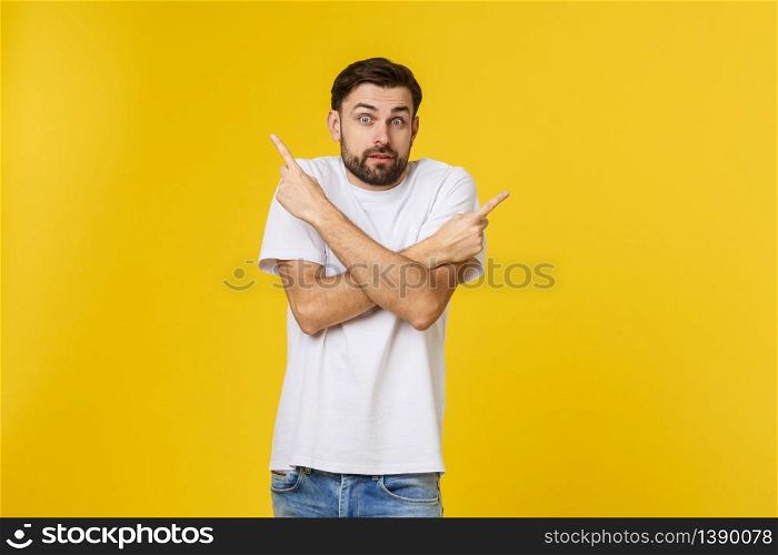 Handsome man over isolated yellow wall frustrated and pointing to the front. Handsome man over isolated yellow wall frustrated and pointing to the front.