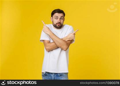 Handsome man over isolated yellow wall frustrated and pointing to the front. Handsome man over isolated yellow wall frustrated and pointing to the front.