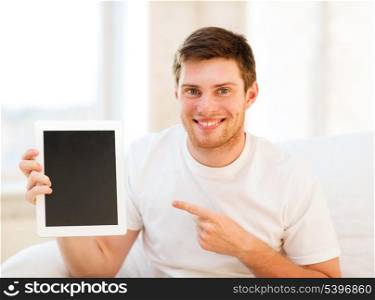 handsome man pointing at tablet pc at home