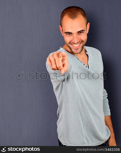 Handsome man pointing finger to camera