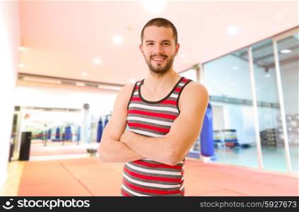 Handsome man portrait at the gym smiling