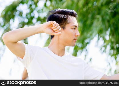 Handsome man practicing thai chi. Handsome man practicing thai chi in the park in the summertime